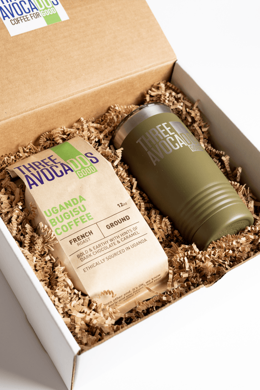 A brown bag of coffee and green tumbler inside of a box, lid open