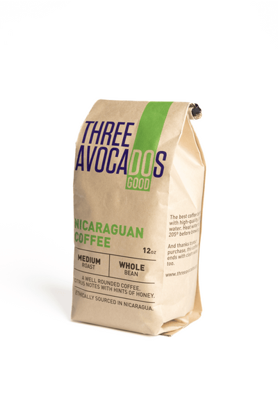 A brown bag of coffee with the label Three Avocados Nicaraguan Coffee, Medium Roast, whole bean