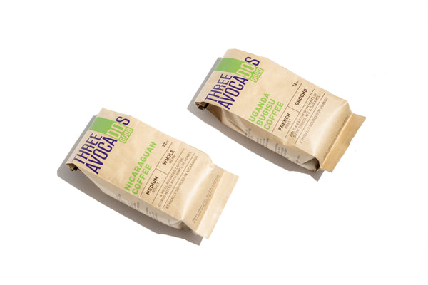 A picture of two bags of coffee. One is Nicaraguan coffee, medium roast, whole bean. The other bag is Uganda Bugisu Coffee, french roast, ground. Both are 12 oz.